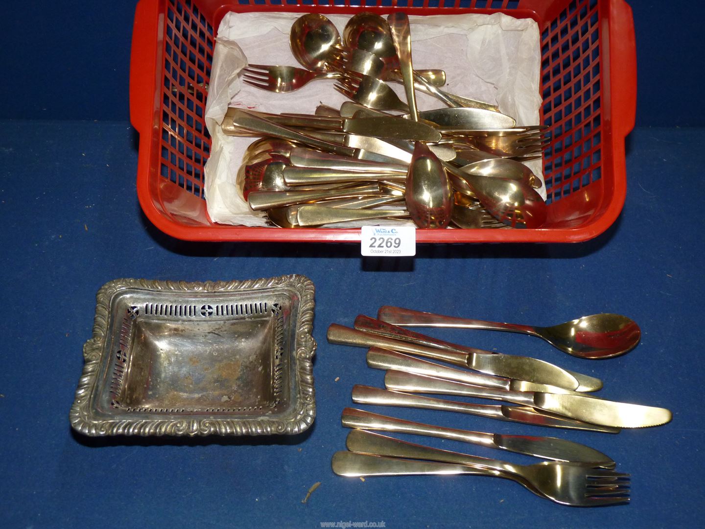 A quantity of cutlery and a plated dish.