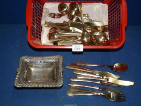 A quantity of cutlery and a plated dish.
