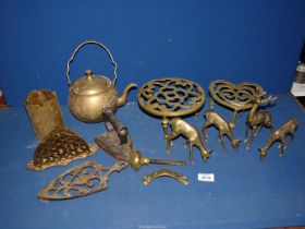 A quantity of brass to include a kettle, four deer, two trivets etc.