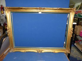 A modern gilt picture frame with added velvet teal inset. 42 1/2" x 30 1/2" overall size.