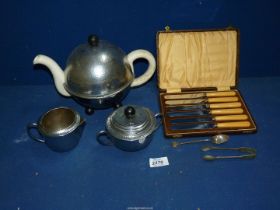An insulated teapot, sugar bowl and jug, cased set of butter knives, etc.