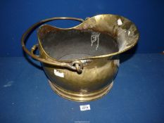 A brass, helmet shaped Coal scuttle.