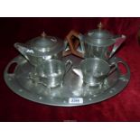 A heavy Art Deco four piece Pewter tea set to include; teapot, hot water jug,