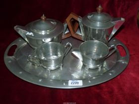 A heavy Art Deco four piece Pewter tea set to include; teapot, hot water jug,