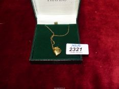 An 18ct gold heart necklace, 30" long, heart locket and chain stamped 750.