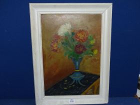 An Oil on canvas of flowers in a tripod vase signed honorable Phoebe Dolman.