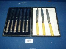 A cased set of silver handled butter knives and three silver collared dessert knives,