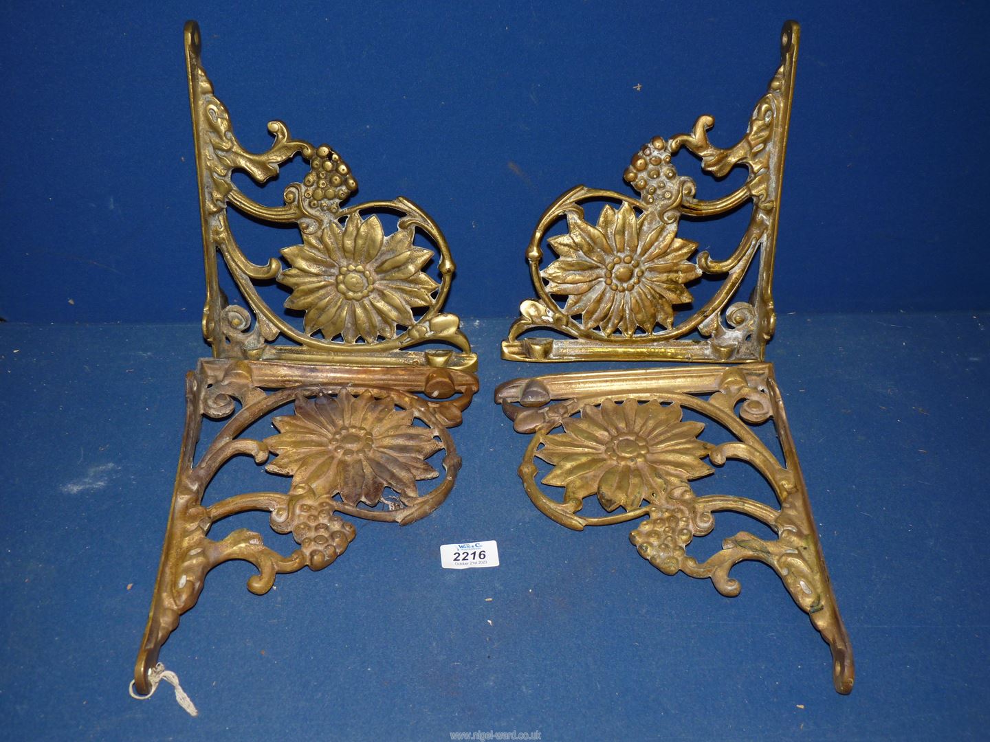 A set of four heavy ornate Brass wall brackets decorated with sunflowers and berries,