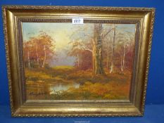 A framed Oil on canvas of an autumnal wood scene, signed lower left indistinct 'Kingswood',