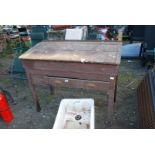 An old school desk with lower drawer and lift up top,