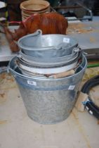 A quantity of galvanised and enamel buckets.