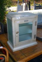 A metal glass fronted medicine Cabinet (no key).