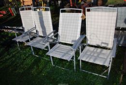 Four folding steel/fabric patio chairs.