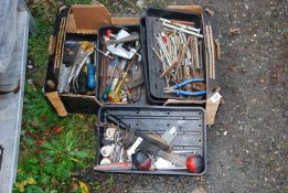 A box containing various tools, large screws, and tin snips, etc.