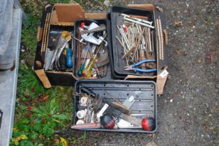 A box containing various tools, large screws, and tin snips, etc.