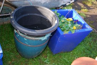 A blue glazed planted pot of pansies, plus two other planters.