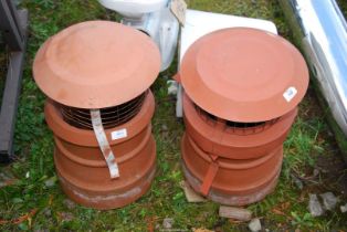 Two chimney pots with cowls.