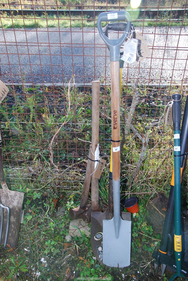 A spade, shovel, and two sledge hammers.