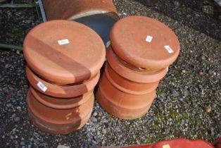 Two chimney pots with pepper pot cowls.