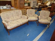 An Ercol two seater settee and two chairs.