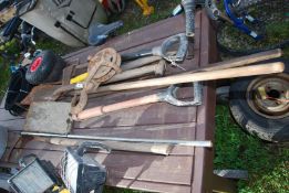 Axe, spades, cultivators and rope pulley.