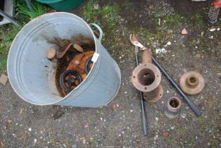 Old cast iron water pump head, cast iron ground firmer, wheels and wood brace.