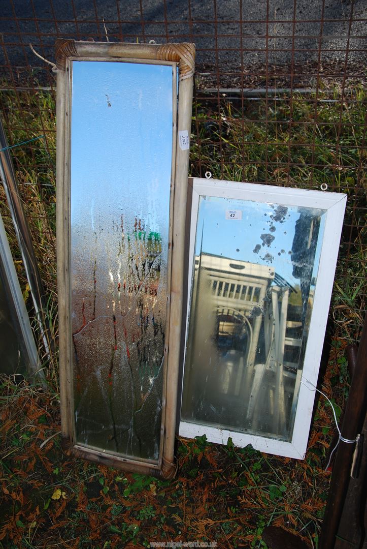 Two mirrors - one having bamboo surround.