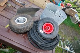 A galvanised mop bucket, two wheels and tyres 260/85, and a roll of 5/16 rubber hose.