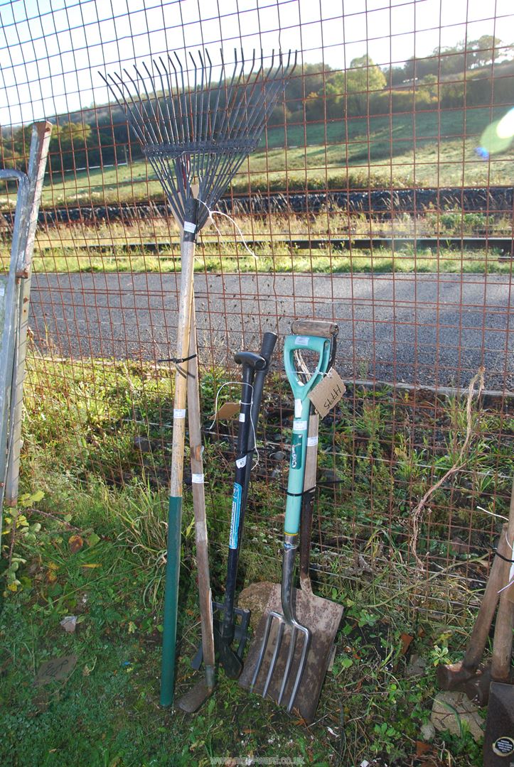 A fork, shovel, a lawn edger, crowbar lift bar, a hoe and a rake.