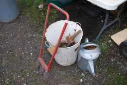 A galvanised watering can and large enamel bin of various spanners, etc.