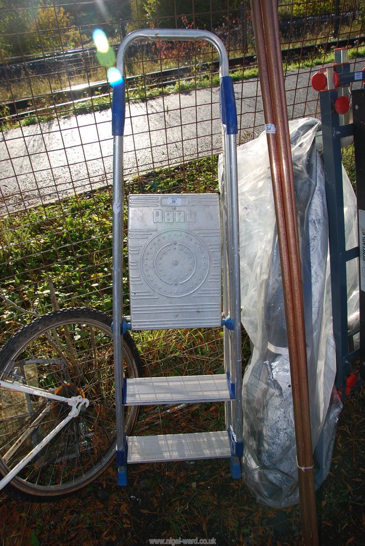 A three rung aluminum step ladder.