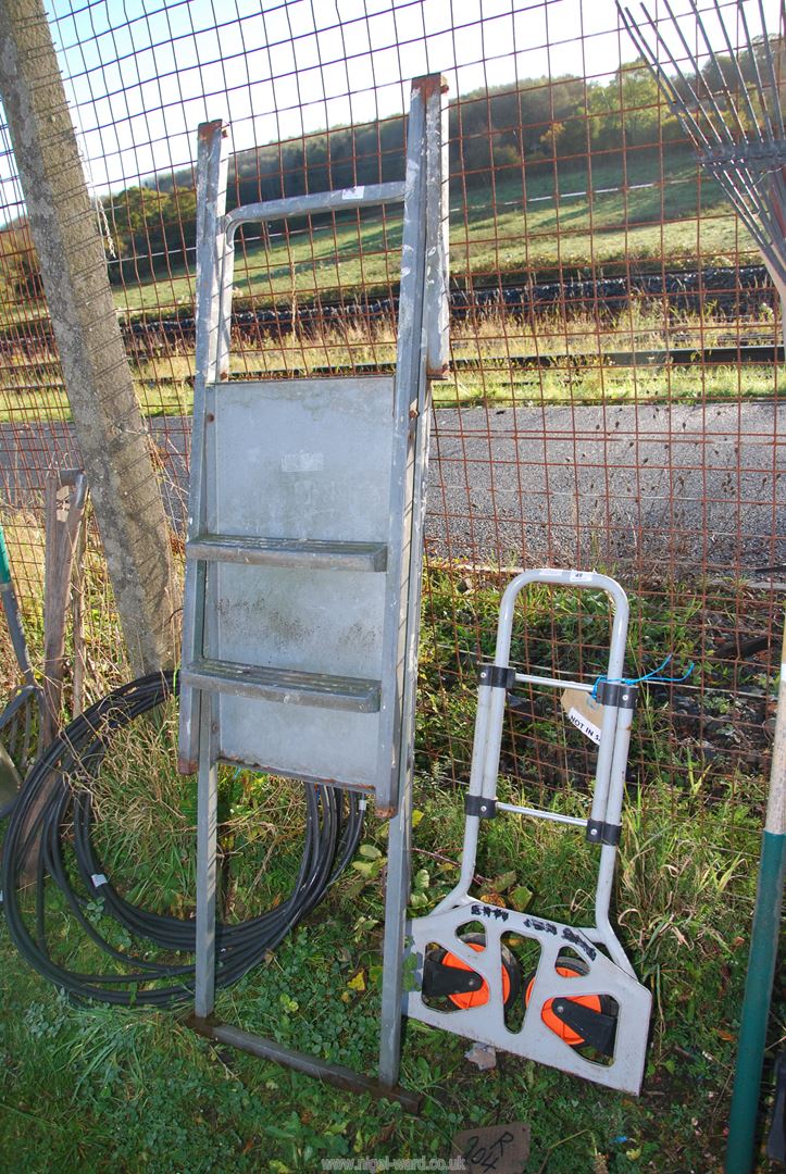 A small fold up sack truck and a step platform.