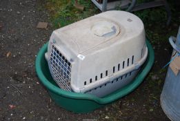 A large plastic dog bed and a cat house.