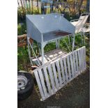 A galvanised potting stand and a galvanised greenhouse staging.