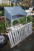A galvanised potting stand and a galvanised greenhouse staging.