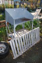 A galvanised potting stand and a galvanised greenhouse staging.