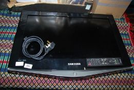 A Samsung flat screen TV with a remote 26" screen.