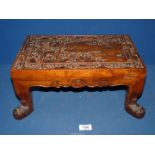 An Oriental carved wooden footstool with bamboo leaves, 15 1/4" wide x 9 3/4" deep x 7" high.