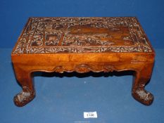An Oriental carved wooden footstool with bamboo leaves, 15 1/4" wide x 9 3/4" deep x 7" high.