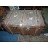 A bentwood bound trunk with leather corners, remains of luggage labels attached,