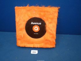 A first edition 'Avenue Q, The Book' with a bright orange faux fur cover.