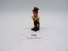 A Royal Doulton character figure of a countryman polishing his boots, 10cm tall.