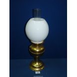 A brass Oil lamp (working) with milk glass globe shade, 19 1/2" tall.