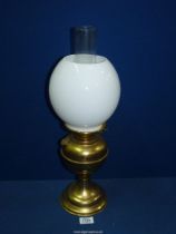 A brass Oil lamp (working) with milk glass globe shade, 19 1/2" tall.