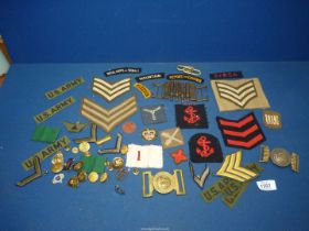 A quantity of military buttons and fabric patches including U.S Army, Royal Corps of Signals etc.