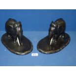 Two Ebony elephants, both a/f, standing on a wooden plinth, 11 1/2" x 7" high.