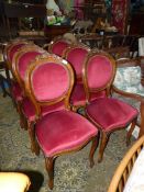 A set of Mahogany/Walnut framed oval backed dining chairs standing on front cabriole legs and