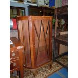 A Walnut finished china display Cabinet standing on brief cabriole legs,