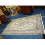A large bordered, patterned and fringed Rug in floral pattern, 9'11" x 6'7".