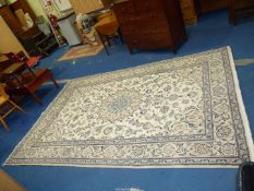 A large bordered, patterned and fringed Rug in floral pattern, 9'11" x 6'7".